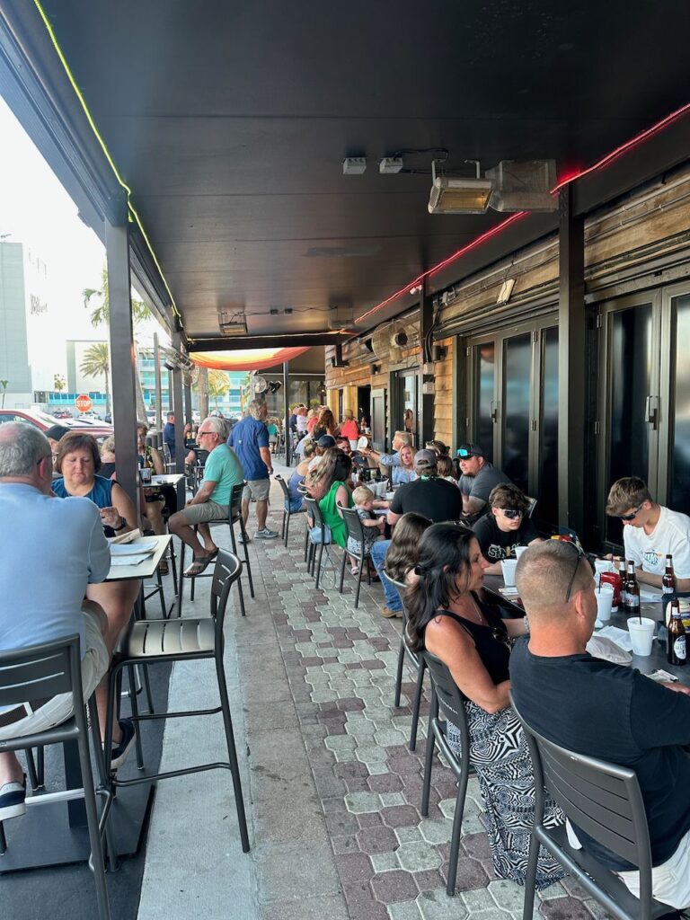 Covered open-air bar walkway with high-top seating at Ricky T's