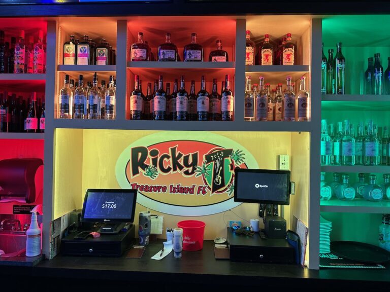 Illuminated Ricky T's Treasure Island FL logo behind the bar